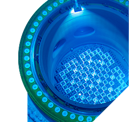 A blue-lit pool with nuclear fuel at the bottom