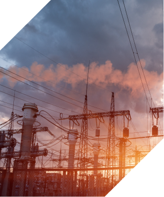 Powerlines and a power plant at sunset