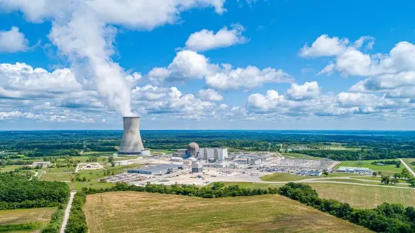 Large nuclear facility and tower surrounded by farmland