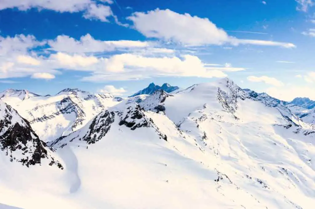 Snow-covered mountain range on a sunny, blue-sky day