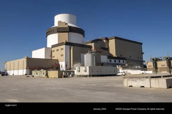 Large cement building with a nuclear tower