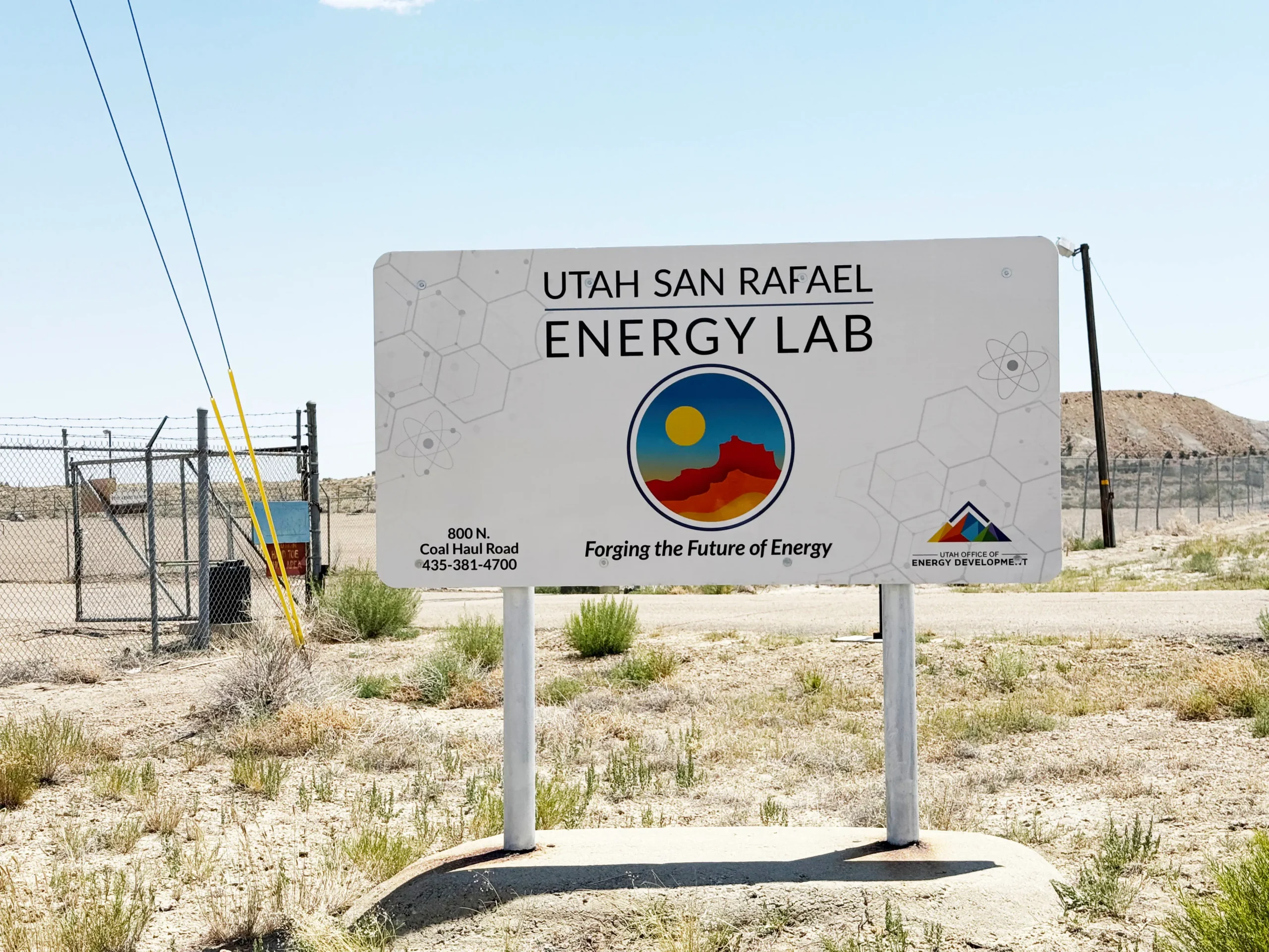 Large outdoor sign for San Rafael Energy Lab located in the desert